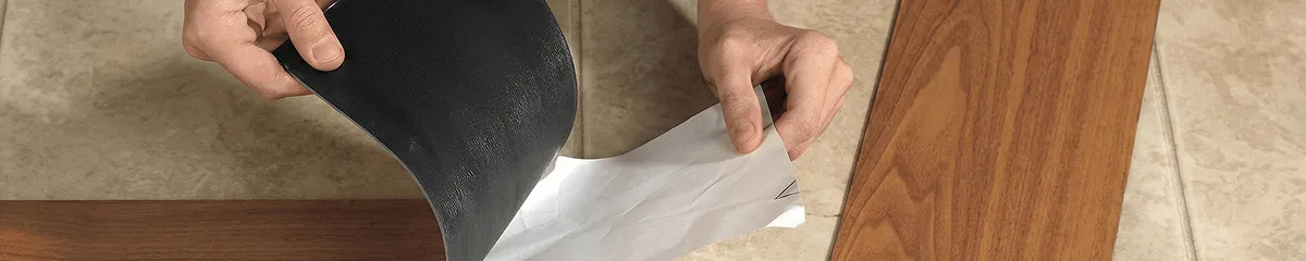 A professional installing vinyl flooring in Kansas City, MO